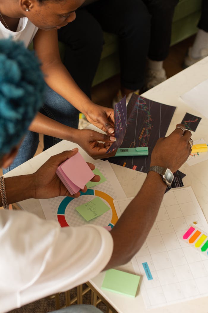 services-04 Team brainstorming session with charts, sticky notes, and diverse collaboration in an office setting.